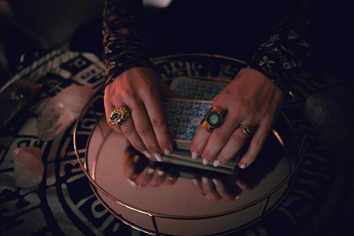 An image of hands dealing the tarot cards